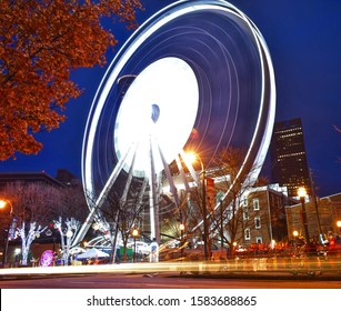 Atlanta Ferris Wheel Illuminated At Night With Light Trails And Nearby Foliage