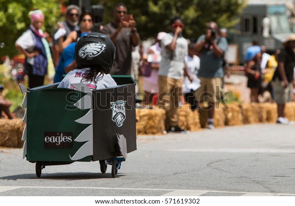 ATLANTA, GA - AUGUST 13:  A girl\
steers her homemade car downhill in the Cool Dads Rock Soap Box\
Derby in the Old Fourth Ward, on August 13, 2016 in Atlanta,\
GA.