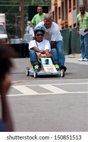  ATLANTA, GA - AUGUST 3:  A Father Pushes His Daughter's Car To Begin Her Run In The Cool Dads Rock Soap Box Derby, At The Old 4th Ward Park On August 3, 2013 In Atlanta. 