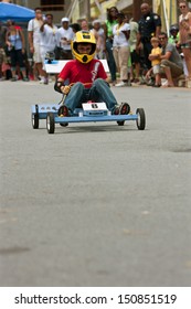  ATLANTA, GA - AUGUST 3:  An Unidentified Kid Steers A Toy Car Down A Hilly Street In The Cool Dads Rock Soap Box Derby, At The Old 4th Ward Park On August 3, 2013 In Atlanta. 