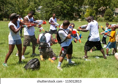 ATLANTA, GA - JULY 28:  Unidentified People Take Part In A Water Gun Battle Called The Fight4Atlanta, A Squirt Gun Fight Between Dozens Of Locals At Freedom Park On July 28, 2012 In Atlanta.