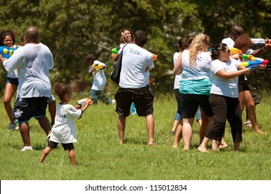 ATLANTA, GA - JULY 28:  Unidentified People Take Part In A Water Gun Battle Called The Fight4Atlanta, A Squirt Gun Fight Between Dozens Of Locals At Freedom Park On July 28, 2012 In Atlanta.