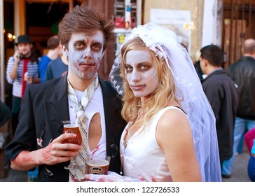 ATLANTA, GA - OCTOBER 20:  An unidentified couple dressed like a zombie bride and groom, enjoy a cold beer after walking in the Little Five Points Halloween parade on October 20, 2012 in Atlanta.