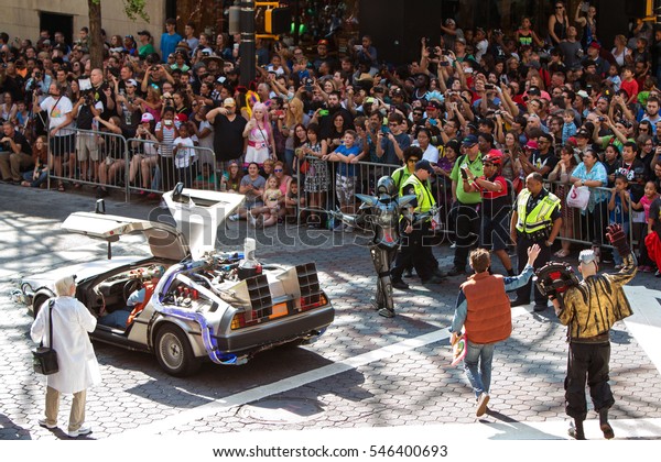 ATLANTA, GA - SEPTEMBER 3: The famous Delorean car\
and characters from the Back to the Future movies wave to\
spectators along the Dragon Con parade route  on September 3, 2016\
in Atlanta, GA.