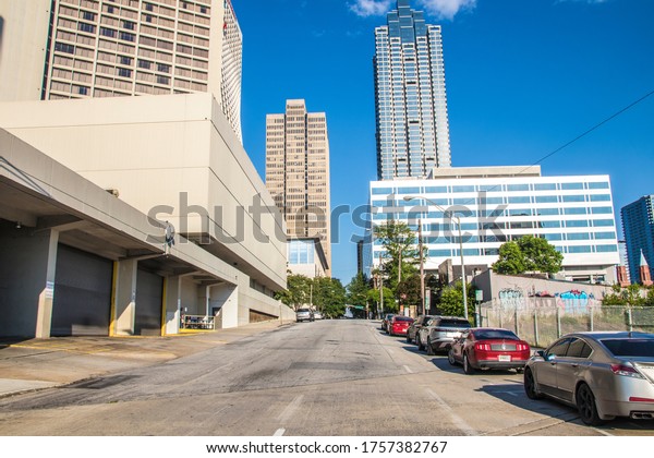 Atlanta, Ga\
USA - 06 07 20: City skyline and buildings downtown Atlanta Georgia\
row of parked cars clear blue sky\
day