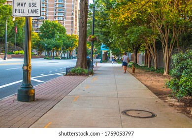  Atlanta, Ga / USA - 06 14 20: Lady Walking A Dog On The Sidewalk Downtown