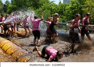 ATLANTA, GA , USA - APRIL 28, 2012:  Women Competing In The Dirty Girl Mud Run, Run Through A Mud Pit And Get Soaked With A Hose As They Near The Finish Of The Women Only Race On April 28, 2012 In Atlanta.