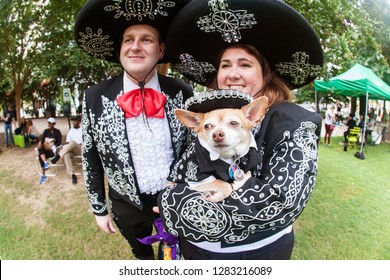 Atlanta, GA / USA - August 18 2018:  A Couple And Their Chihuahua Are Dressed In Mariachi Costumes At Doggy Con, A Dog Costume Contest In Woodruff Park On August 18, 2018 In Atlanta, GA.