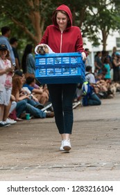 Atlanta, GA / USA - August 18, 2018:  A Young Woman Dressed As Elliot From The Movie E.T. Carries Her Dog In A Basket, Dressed Like The Extraterrestrial, At Doggy Con In Atlanta. 