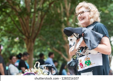 Atlanta, GA / USA - August 18 2018:  A Woman Carries A Small Dog Dressed Like Darth Vader From Star Wars As She And Her Dog Participate In Doggy Con, A Dog Costume Contest In Atlanta, GA.