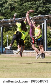 Atlanta, GA  USA - June 1, 2019:  Men Playing A Recreational Flag Football Game Jump In Unison To Catch Or Defend A Pass Thrown At The Old Fourth Ward Park On June 1, 2019 In Atlanta, GA. 