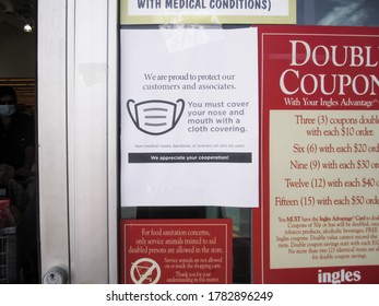 ATLANTA, GEORGIA - JULY 24, 2020 : Mask Or Face Covering Required Sign On Entry Door Of Ingles Grocery Store. Corona Virus (COVID-19) Has Prompted Many Retailers To Require Cloth Face Coverings.