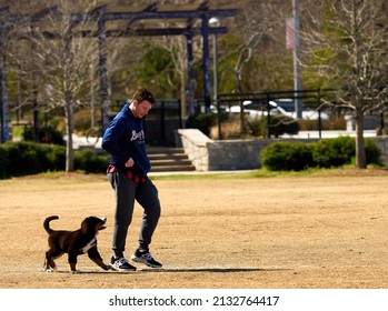ATLANTA, GEORGIA - MARCH 6, 2022: Many people utilize the parks along the Atlanta Beltline to train dogs to walk on a leash.