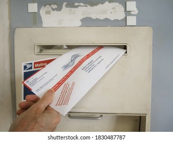 ATLANTA, GEORGIA - OCTOBER 9, 2020 : Absentee Voter Mailing Vote By Mail Ballot At A U.S. Post Office Mailbox.