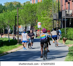 ATLANTA, GEORGIA / UNITED STATES - APRIL 2, 2020: Atlanta Beltline during COVID-19 pandemic, people social distancing while walking and riding bikes.