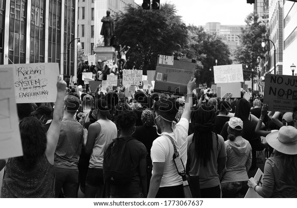 Atlanta, Georgia / United States - May 29 2020:\
Protestors gather and demonstrate against police brutality in\
Atlanta, GA, near the CNN Center, following the death of George\
Floyd and Ahmaud\
Arbery.