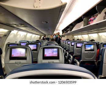 ATLANTA, GEORGIA, USA - OCT 18, 2018: Delta Airline Airplane Interior With People Boarding