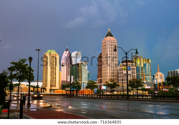 Atlanta, USA. Illuminated Midtown in Atlanta, USA\
at night. Car traffic, illuminated buildings and dark sky. Car\
traffic trails