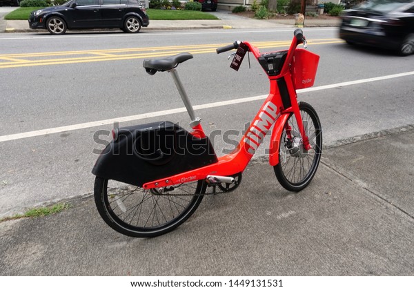 Atlanta,GA/USA-7/7/19: A Jump Bicycle share\
bike on the sidewalk waiting for its next patron to hop on a ride\
to its next\
location.