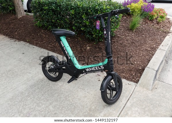 Atlanta,GA/USA-7/7/19: Wheels ride share\
bicycle waiting for it\'s next rider to select it from the Wheels\
app and take off to the next\
location.