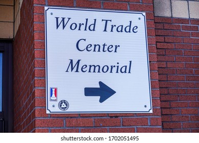 Atlantic City, New Jersey - March, 2020: White Textured Sign With A Blue Border On A Red Brick Wall That Shows The Direction To The World Trade Center Memorial