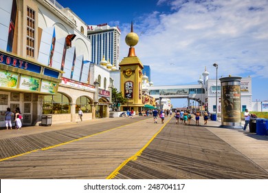 ATLANTIC CITY, NEW JERSEY - SEPTEMBER 9, 2012: Tourists walk on the boardwalk in Atlantic City.