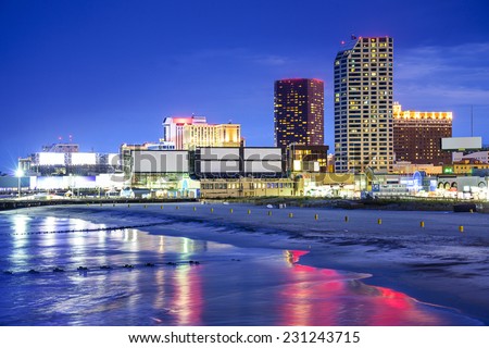 Atlantic City, New Jersey, USA resort casinos cityscape on the shore at night.