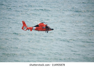 ATLANTIC CITY, NJ - AUGUST 24: US Coast Guard HH-65A Dolphin Helicopter Drops Rescue Diver During Rescue Exercise August 24, 2011 In Atlantic City, New Jersey