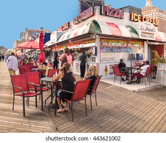 ATLANTIC CITY, NJ - SEPTEMBER 22, 2013: View of food concession stand along the boardwalk at Atlantic City with people visible.