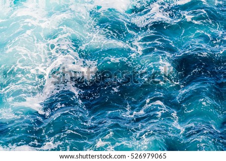 Atlantic ocean with blue water on a sunny day. Waves, foam and wake caused by ship in the sea, wave rippled effect filtered image for creative graphic design concept, water background, website banner