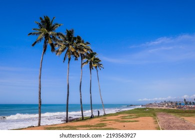 Atlantic Ocean Coastline With The Turquoise Waves Among The Palm Trees In Elmina City In Ghana, West Africa