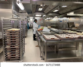 Atlantic, Ocean, December 22, 2019: Chef Is Cooking On A Large Cruise Ship Galley. Stainless Steel Kitchen In A Huge Hotel. A Lot Of Food.