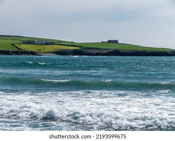 The Atlantic Ocean In The South Of Ireland. Beautiful Seascape, Sunny Warm Weather. A Beautiful Place On The Seashore. The Blue Water Of The Celtic Sea. Green Field Near Water