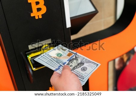 Atm machine bitcoin cryptocurrency. Usd hundred money payment on virtual crypto currency btc wallet. Woman withdraw american dollar bill money. Atm machine finance and technology concept