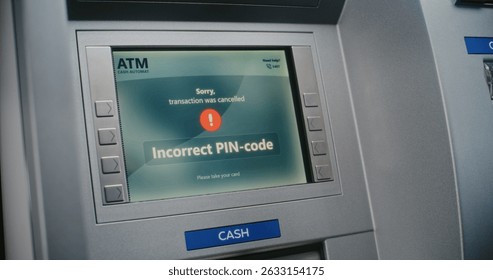 ATM User Entering PIN Code on ATM Keypad for Money Withdrawal. Error Message on Cash Machine Screen About Cancelled Transaction Due to Incorrect PIN Code. Cash Transactions, Banking System. Close Up.