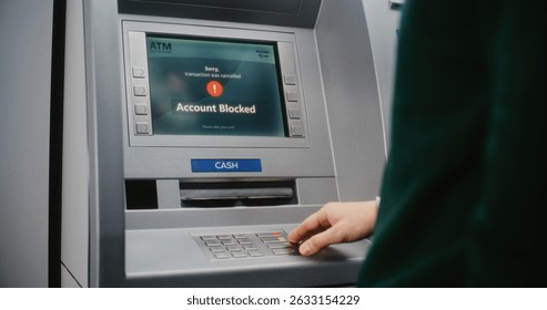 ATM User Entering PIN Code on ATM Keypad for Money Withdrawal. Error Message on Cash Machine Screen About Cancelled Transaction Due to Blocked Bank Account. Cash Transactions, Banking System. Close Up
