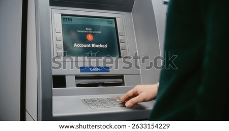 ATM User Entering PIN Code on ATM Keypad for Money Withdrawal. Error Message on Cash Machine Screen About Cancelled Transaction Due to Blocked Bank Account. Cash Transactions, Banking System. Close Up