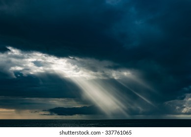 Atmosphere beautiful dramatic clouds with sun rays on dark heaven.
Climate catastrophe thunderstorm, hurricane, overcast scene in twilight