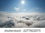 Atmosphere of flying above clouds. Sky thunderclouds, horizon line from an airplane drone. Creative background for design. Dawn, sun over clouds - positive travel concept of meditative joy of future