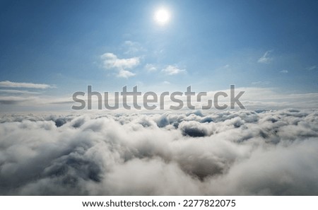 Atmosphere of flying above clouds. Sky thunderclouds, horizon line from an airplane drone. Creative background for design. Dawn, sun over clouds - positive travel concept of meditative joy of future