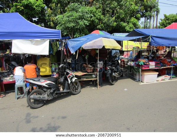 the atmosphere of the\
highway that turns into a market while many traders and buyers\
transact directly using cash. Semarang Central Java Indonesia -\
October 17th 2021