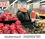 atmosphere in the supermarket. In the fruit display case there are watermelon and dragon fruit