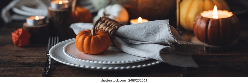 Atmospheric autumn elegant beautiful table setting with pumpkins for a wedding or thanksgiving family celebration. Fall decoration countryside rustic style, cozy home atmosphere , candles, wine banner - Powered by Shutterstock