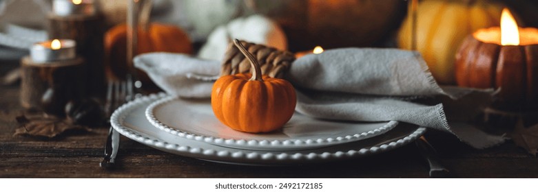 Atmospheric autumn elegant beautiful table setting with pumpkins for a wedding or thanksgiving family celebration. Fall decoration countryside rustic style, cozy home atmosphere , candles, wine banner - Powered by Shutterstock