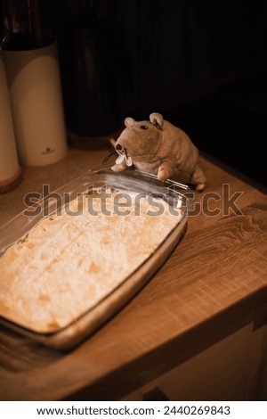 An atmospheric image capturing a rat expertly cooking in a cozy kitchen environment, exuding warmth and culinary charm
