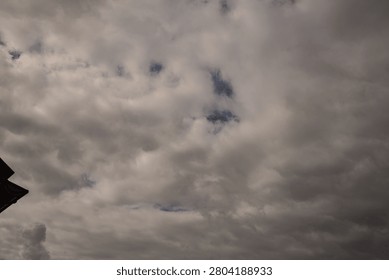 Atmospheric Storm Front with Dramatic Cloud Formation. Rain Filled Thunderclouds Covering the Sky Before the Storm. Dark dramatic storm clouds gathering in the sky before heavy rainfall. Atmospheric cloudscape featuring dense cumulonimbus formations, overcast weather, and approaching thunderstorm. Perfect background for weather, climate, meteorology, nature, environmental concepts, forecasts, dramatic skies, and seasonal weather themes.