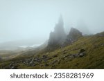 Atmospheric view of high sharp cliffs covered in fog. The Old Man of Storr covered in fog. The Isle of Skye, Scotland, UK