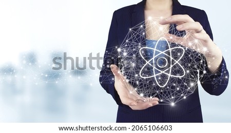 Atom molecule as concept for science. Two hand holding virtual holographic molecule atom icon with light blurred background. Atom molecule abstract.