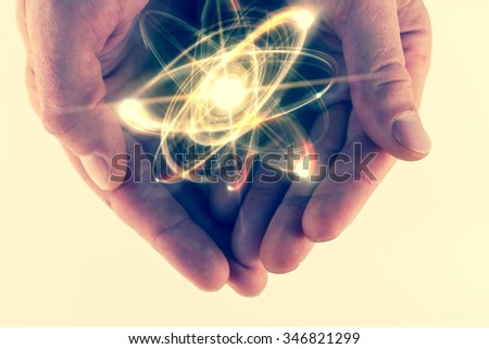 Atomic orbitting particle being held in cupped hands