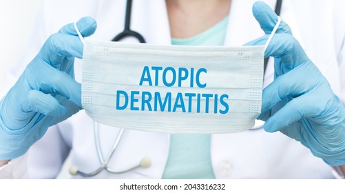 Atopic Dermatitis, Text On Blue Protective Mask In The Hands Of A Doctor, Medical Concept